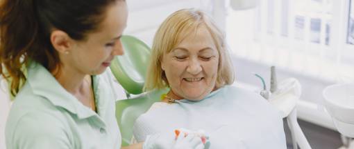 Senior patient with dentist on dental clinic
