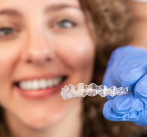 Orthodontic Specialist Adjusting and Placing Invisible Aligners on Woman